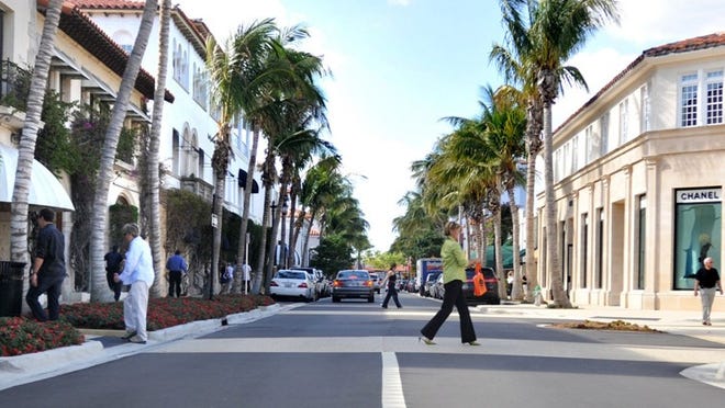 Royal palms accent Worth Avenue where the 100 Years of Fashion event will take place on Nov. 16.