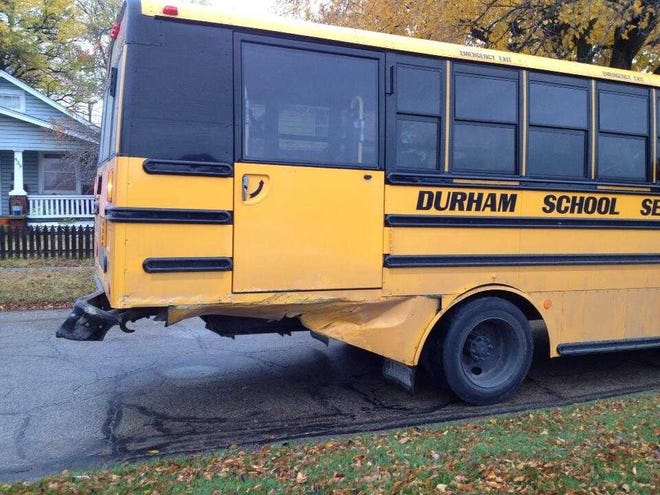 A car struck a school bus from behind Tuesday afternoon, injuring the car's driver.