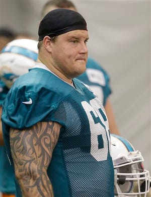 FILE - In this May 29, 2013 file photo, Miami Dolphins guard Richie Incognito watches during an NFL football practice at the Dolphins training facility in Davie, Fla. Suspended Dolphins guard Incognito sent text messages to teammate Jonathan Martin that were racist and threatening, two people familiar with the situation said Monday, Nov. 4, 2013. The people spoke to The Associated Press on condition of anonymity because the Dolphins and NFL haven't disclosed the nature of the misconduct that led to Incognito's suspension.