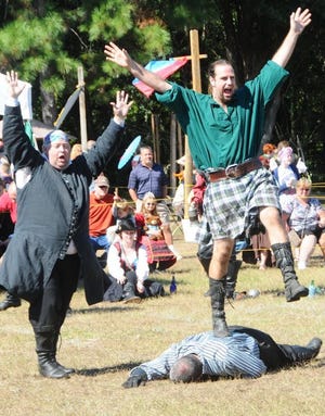 Adam Richardson, right, portraying Malcom Gwylleth MacDurron, reacts to reacts to victory in the human combat chess match for land and titles.