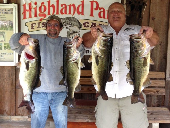 Dave Stout, left, and Capt. Rick Rawlins pose with part of their 15 bass catch up to 9 pounds. All were released.