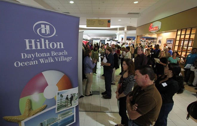 Hundreds of people wait in lines at Thursday;s job fair at Volusia Mall in Daytona Beach. The event was put on by the city.