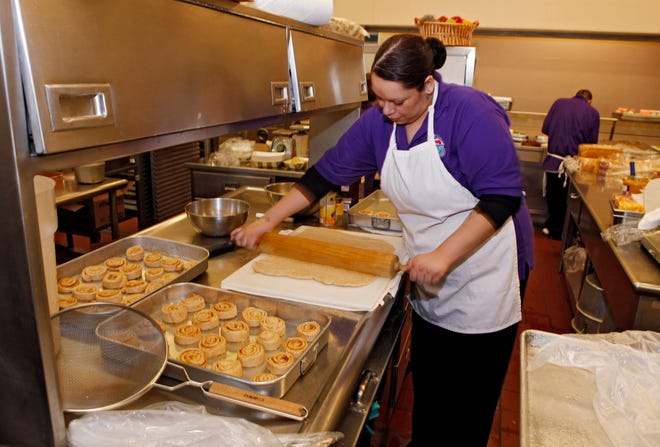 Alexes Garcia makes cinnamon rolls for student's lunch in the kitchen on Jan. 18 at Kepner Middle School in Denver. The rolls are made using apple sauce instead of trans fats.
