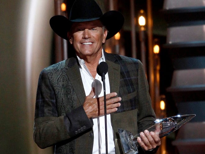 George Strait accepts the award for entertainer of the year at the 47th annual CMA Awards at Bridgestone Arena on Wednesday, Nov. 6, 2013, in Nashville, Tenn.