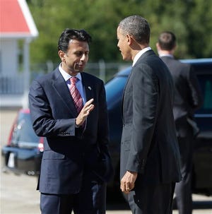 President Barack Obama is greeted by Louisiana Gov. Bobby Jindal on the tarmac upon his arrival on Air Force One today at Louis Armstrong International Airport in New Orleans