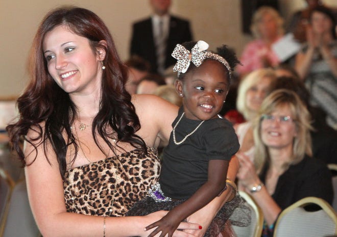 Paige Auborn and daughter Arianna are all smiles after Arianna’s adoption was made final during a National Adoption Day ceremony 2013 at Sunset Harbor on Friday.
