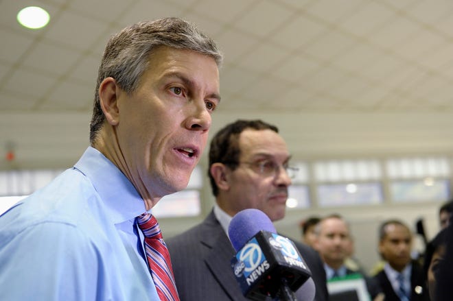 Education Secretary Arne Duncan, left, stands with Washington Mayor Vincent Gray, as he speaks to reporters Thursday during a visit to Malcolm X Elementary School in Washington. Today's fourth and eighth graders are doing better than their predecessors in math and reading, but despite record high scores it's too soon to start celebrating.