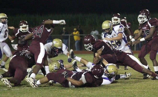 White Castle's Brian Jenkins, Brandon Foster, Daniel Edwards, Jared Little, Andre Prevost, Jared Jones, Moses Young, Robert Franklin and Harold Zachary converge on a fumble in the fourth quarter of the Bulldogs' 14-12 District 8-1A victory over Ascension Catholic on Friday night at Milton “Rocky” Ourso Jr. Stadium. 
POST SOUTH PHOTO/Peter Silas Pasqua