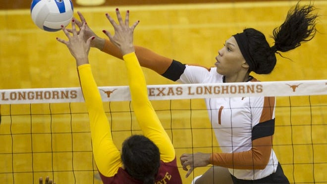 UT’s Khat Bell hits the ball as Iowa State’s Tenisha Matlock tries to defend at Gregory Gym last month. Bell is third in points and kills for the Longhorns.
