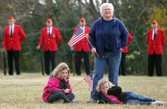 ‘Pucky’ Nantz attends a Veterans Day observance ceremony with her granddaughters Karlee, 8, left, and Mollie, 4, right, at Patriots Park in Kings Mountain in 2012.