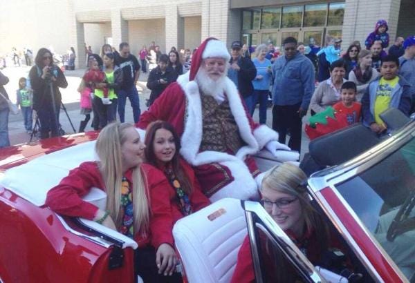 Riding in a red 1967 Oldsmobile 442 convertible, Santa Claus makes his arrival Saturday morning at West Ridge Mall, 1801 S.W. Wanamaker. Santa will be at the mall daily through Dec. 24, except Thanksgiving.