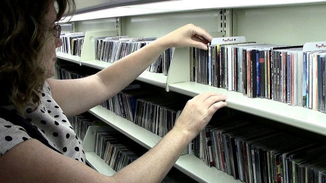 Reporter Marion Callahan sifts through the vast amount of CDs the Bucks County Free Library in Doylestown has to offer. The library has free resources that are now available.