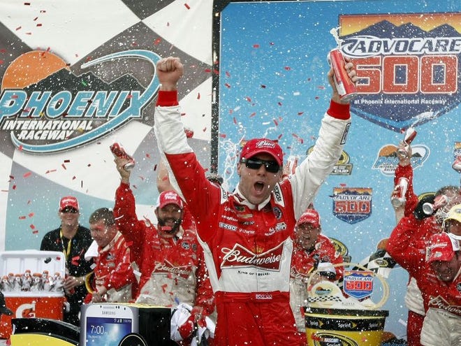 Kevin Harvick, center, celebrates in Victory Lane after winning the Sprint Cup Series AdvoCare 500 at Phoenix International Raceway on Sunday in Avondale, Ariz.