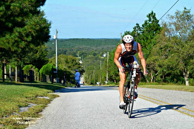 Eric Graveling of Deltona rides up one of the hills during the Great Floridian Triathlon last month in Clermont. Graveling won the race, finishing in 10:23:28.