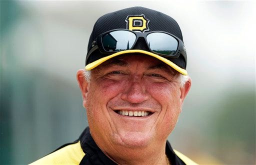 Pittsburgh Pirates manager Clint Hurdle smiles as he makes his way to the field before a baseball spring training workout Wednesday, Feb. 13, 2013, in Bradenton, Fla. Hurdle was named the 2013 NL Manager of the Year. (AP Photo/Charlie Neibergall)