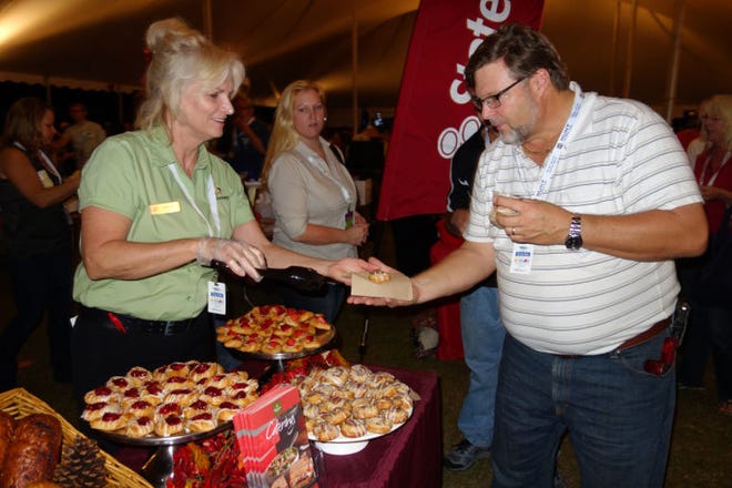 Panera Bread’s Debi Hall gave Rick Scherer of Winter Garden the lowdown on the pastries she was sampling at the South Lake Chamber of Commerce’s third annual Taste of South Lake and Business Expo at Clermont’s Waterfront Park on Nov. 7.