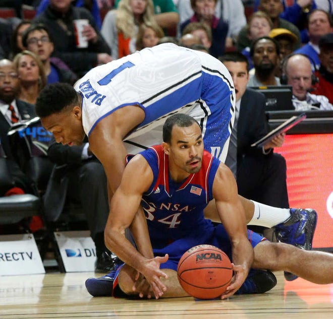 Kansas forward Perry Ellis (34) steals a pass intended for Duke forward Jabari Parker during the first half of an NCAA college basketball game on Tuesday, Nov. 12, 2013, in Chicago. (AP Photo/Charles Rex Arbogast)
