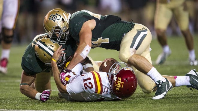 Baylor linebackers Eddie Lackey, left, and Bryce Hager, top, a former Westlake standout, help power a top-10 defense that has been one of the surprises of college football. (Jerome Miron/USA Today)