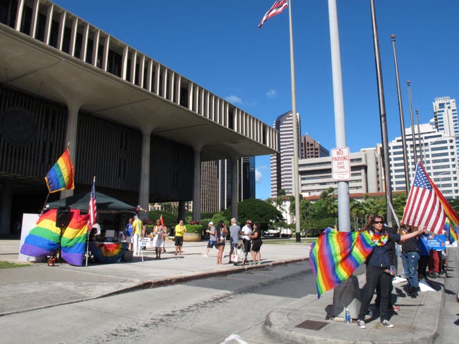 Gay marriage supporters rally outside the Hawaii Capitol in Honolulu ahead of a Senate vote on whether to legalize same-sex marriage on Tuesday, Nov. 12, 2013. The bill allowing same-sex couples to wed on the islands starting Dec. 2 passed and was signed by the governor Wednesday.