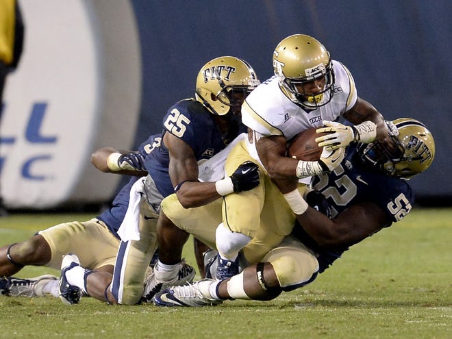 Running back Robert Godhigh and the Georgia Tech triple option offense require discipline to defend.