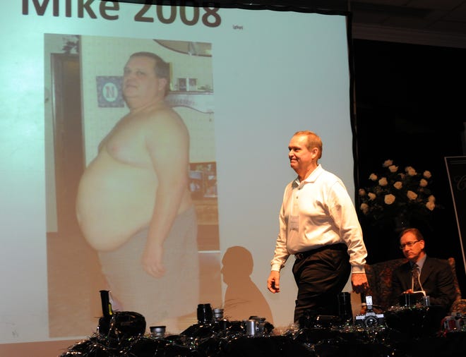 Mike Newton had Gastric Bypass surgery in 2008 and has lost 143 pounds to date. Newton walks across the stage with a before photo on the screen.