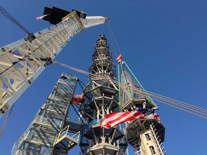 The silver spire topping 1 World Trade Center is fully installed on the building's roof May 10, bringing the structure to its full, symbolic height of 1,776 feet in New York. The tower knocked Chicago's Willis Tower off its pedestal as the nation's tallest building.