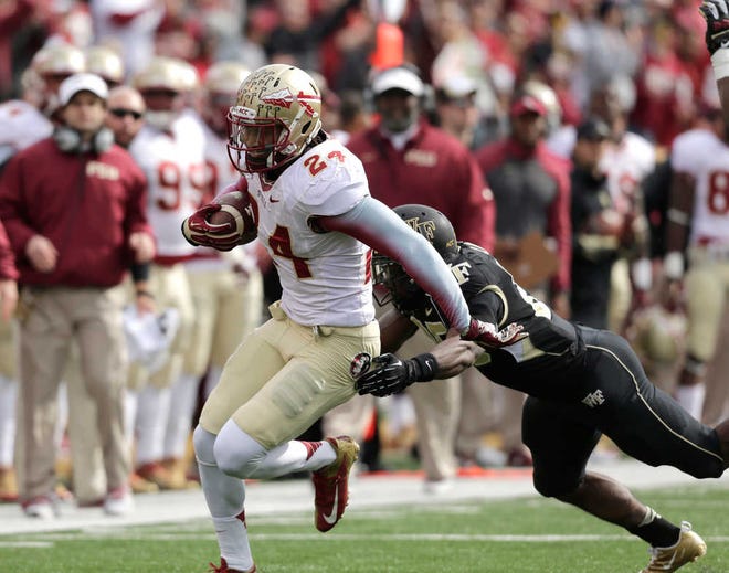 Florida State linebacker Terrence Smith carries the ball after intercepting a Wake Forest pass in the first half of an NCAA college football game in Winston-Salem, N.C., Saturday, Nov. 9, 2013. (AP Photo/Nell Redmond)