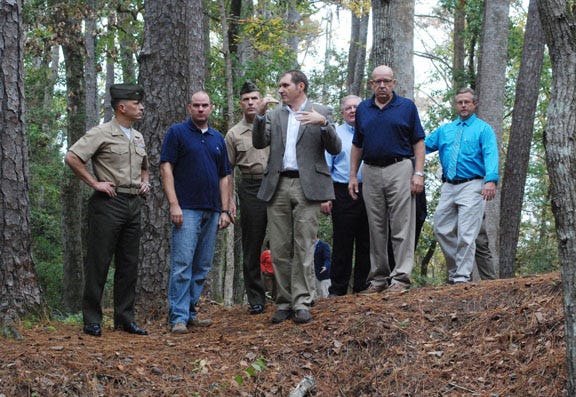 Cherry Point’s commanding officer Col. Chris Pappas III, far left, tours the proposed waterfront park on Slocum Creek. Pictured, from left, are Col. Pappas, Commissioner Will Lewis, Cherry Point Sgt. Major Benjamin Pangborn, consultant Scott Chase, Commissioners Danny Walsh and George Liner and city services director Bill Ebron.