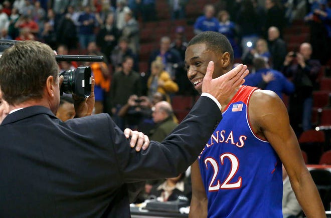 Kansas guard Andrew Wiggins, right, smiles as he receives congratulations from head coach Bill Self after Wiggins scored 22 points in the Jayhawks' 94-83 victory over Duke on Tuesday night in Chicago.