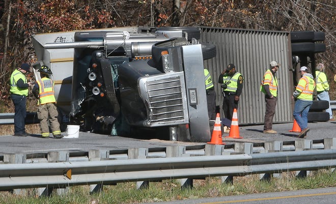 Members of the North Carolina Highway Patrol investigate a wreck involving a tractor-trailer carrying 77 cows that overturned on I-26 westbound on the Saluda Grade on Wednesday. The driver suffered minor injuries. The cattle were transferred to other trailers. Cows that suffered catastrophic injuries were euthanized by a veterinarian.