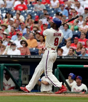 The Phillies' Domonic Brown watches his three-run home run against the Milwaukee Brewers in the first inning of a June game. (AP Photo/H. Rumph Jr)