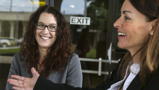 Sarah Wonders, left, and her attorney Erika Rotbart, talk about the verdict in their sexual harassment trial against Jupiter-based United Tax Group November 14, 2013 outside the Federal Courthouse . (Lannis Waters/The Palm Beach Post)