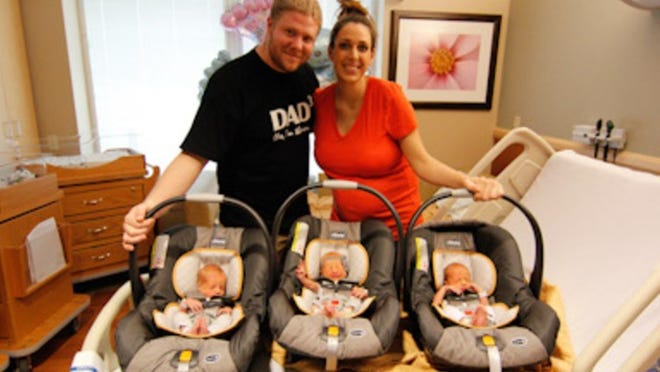 James and Ashley Baker about to leave the hospital with their triplets, from left, Everly, Grayson and Dallen.