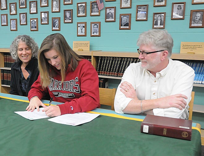 Dighton-Rehoboth pitcher Kelly Madigan, center, signs a letter of intent in front of mom, Ann, and dad, Rob, inside the media center at Dighton-Rehoboth Regional High School.