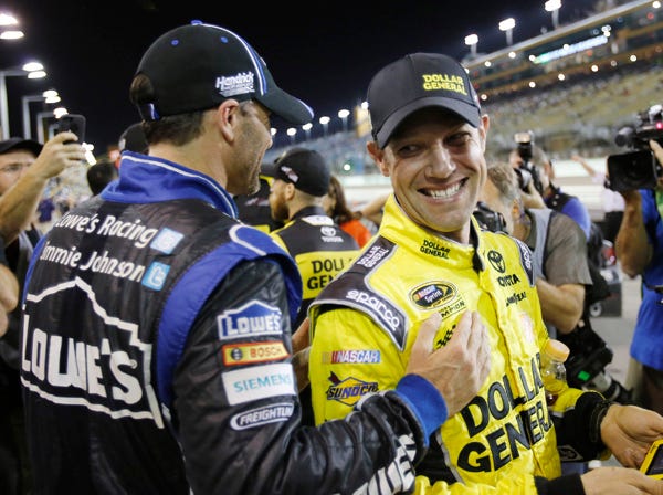 Jimmie Johnson, left, talks to Matt Kenseth Saturday during qualifying for Sunday's race at Homestead.
(Terry Renna | Associated Press)