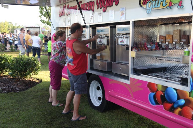 Customers help themselves to some self-serve frozen yogurt during a Food Truck Tuesday event earlier this year. The next food truck gathering is set for Tuesday.