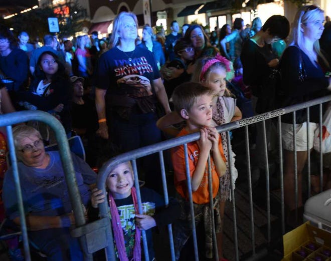 Photos by Bob.Mack@jacksonville.com Sherry Mosley (center) brought her grandchildren (foreground, from left) Logan Shover, 2, Jackson Hancock and his twin sister Mattie, both 9, to watch the St. Johns Town Center's Holiday Spectacular on Saturday night. The event featured costumed characters, a tree-lighting ceremony and a free concert.