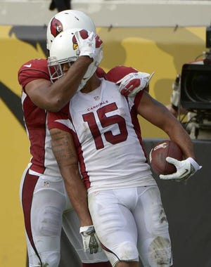 Phelan M. Ebenhack Associated Press Cardinals wide receiver Michael Floyd (15) is hugged by teammate Larry Fitzgerald after his 91-yard scoring play.