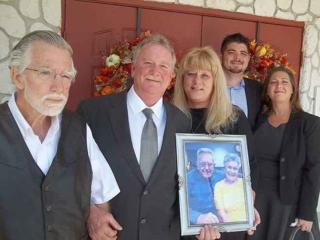 Attending the double funeral service for Peggy and Emory Edmunds were, from left to right, their sons Ricky Edmunds, David Edmunds and his wife Patricia with their son Justin Edmunds and his wife Shane. David and Patricia are holding a photo of the couple, who died three days apart. (Andy Fillmore | The Ocala Star Banner)