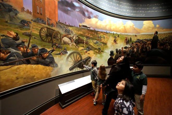 School groups and visitors view the Gettysburg Address and battle mural Friday, Nov. 15, 2013, at the Abraham Lincoln Presidential Museum and Library in Springfield.