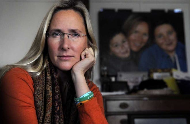 Scarlett Lewis, the mother of Jesse Lewis, the Sandy Hook first grader shot and killed by Adam Lanza after telling his classmates to run, has written a book. Lewis sits in her Sandy Hook home where a painting of her with Jesse and her older son, J.T., hangs in the living room. (John Woike/Hartford Courant/MCT)