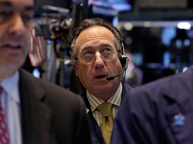Trader Steven Kaplan, center, works on the floor of the New York Stock Exchange Monday, Nov. 18, 2013. The Dow Jones industrial average crossed 16,000 points for the first time early Monday and the Standard & Poor's 500 index crossed 1,800 points.