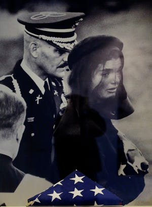 A small new exhibit at the John F. Kennedy Library and Museum marking the 50th anniversary of the assassination of the 35th President of the United States includes never-before-displayed artifacts from his three-day state funeral, such as the American flag which draped the president's casket presented with a photograph of first lady Jacqueline Bouvier Kennedy during her husband's funeral in Boston, Thursday, Nov. 14, 2013.