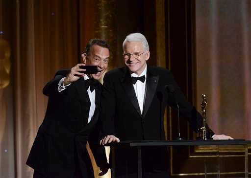 Actor Tom Hanks, left, takes a photo with actor and honoree Steve Martin at the 2013 Governors Awards on Saturday in Los Angeles.