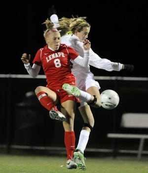 Lizzie Kinkler (8) of Lenape and Breanna Cocuzzo of Montgomery battle for the ball in the first half of Tuesday's group 4 semi-final game at Neptune.