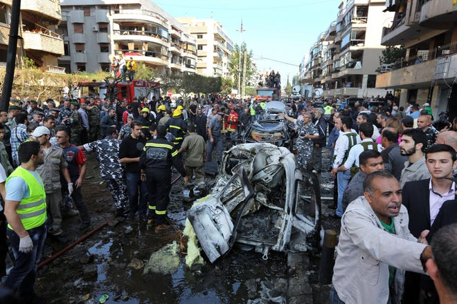Lebanese people gather at the scene where two explosions have struck near the Iranian Embassy killing many, in Beirut, Lebanon, Tuesday, Nov. 19, 2013. The blasts in south Beirut’s neighborhood of Janah also caused extensive damage on the nearby buildings and the Iranian mission. The area is a stronghold of the militant Hezbollah group, which is a main ally of Syrian President Bashar Assad in the civil war next door. It’s not clear if the blasts are related to Syria’s civil war.