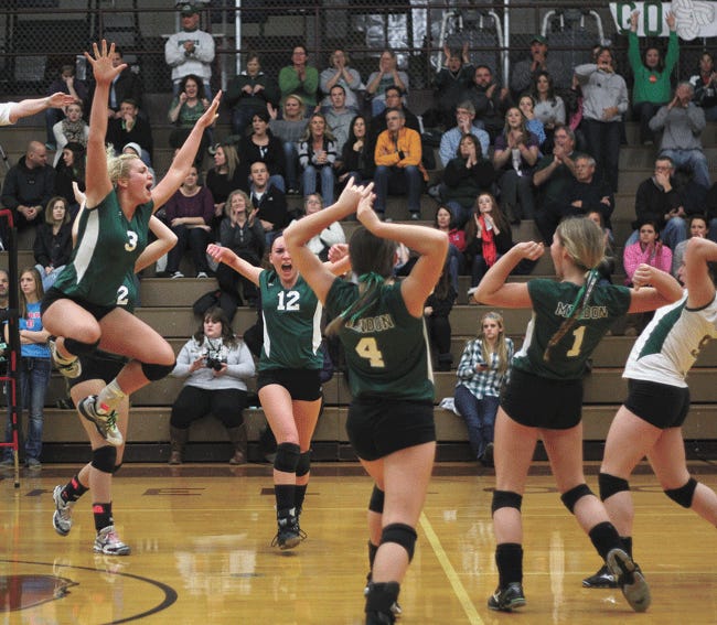 Mendon celebrates a point after a block at the net Tuesday night against Schoolcraft.
