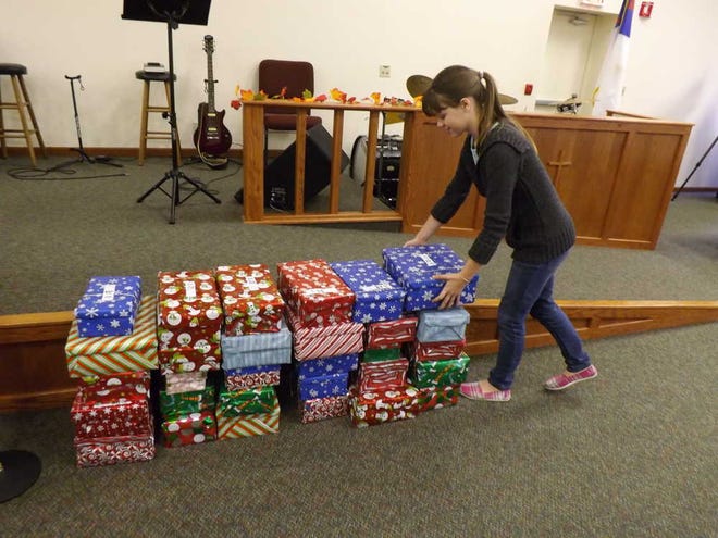 Anna Scott, 12, volunteers Tuesday at Southwest Topeka Bible Church, 4141 S.W. 53rd St., for Operation Christmas Child, a worldwide effort to collect shoeboxes full of gifts for 9.8 million impoverished children throughout the world. Four drop-off sites in the Topeka area will collect shoeboxes through Monday.