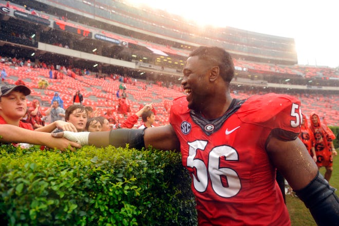 Georgia defensive end Garrison Smith (56) high fives fans after the second half of the NCAA college football game between Georgia and North Texas in Athens, Ga., Saturday, Sept. 21, 2013.