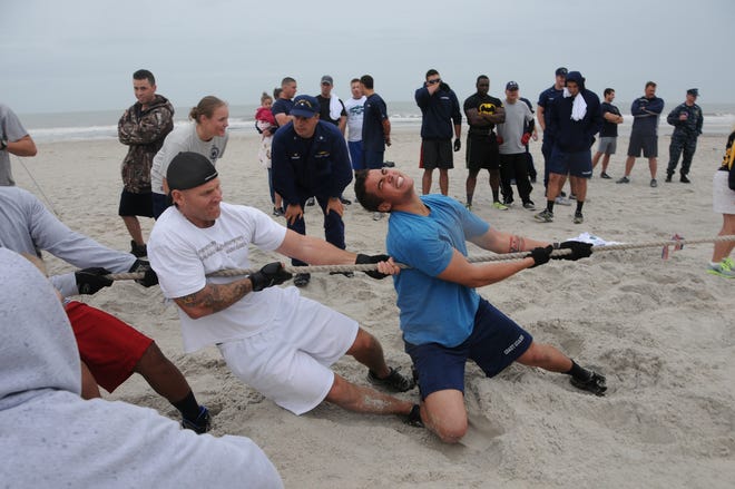 Crewmembers of USCG Cutter Valiant are cheered on as they pull against Sailors from Afloat Training Group Mayport during the Tug-o-War competition at this year's MWR 2013 Fall Sports Challenge. Valiant didn't win the challenge, but they did take home this year's trophy.